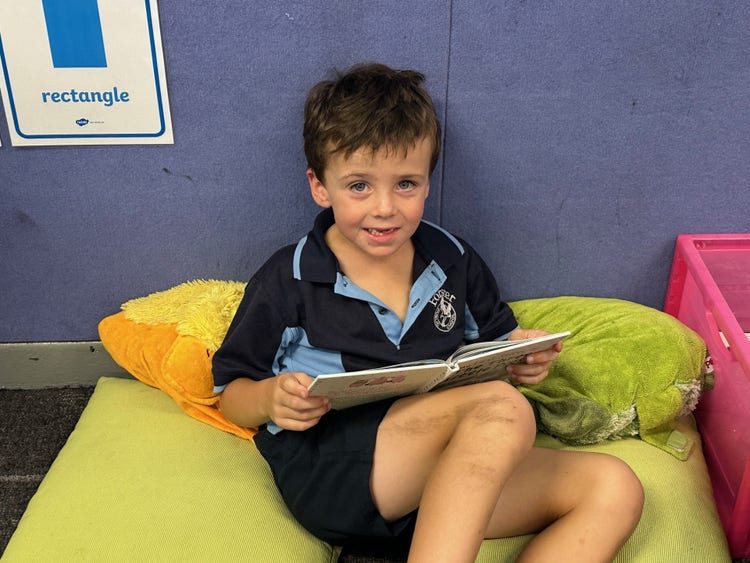 boy reading a book in a beanbag