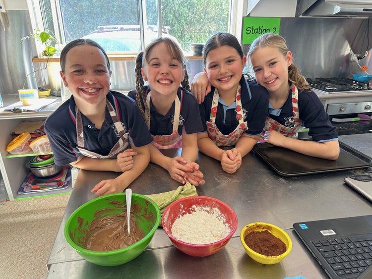 girls smiling and cooking in the kitchen