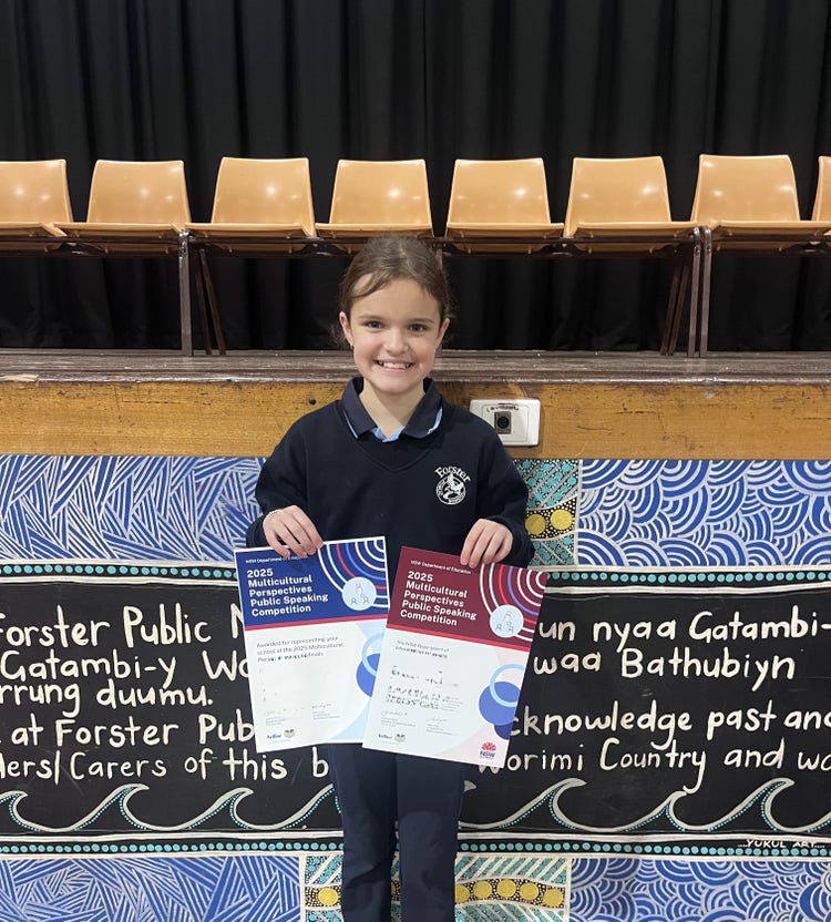 student holding certificates