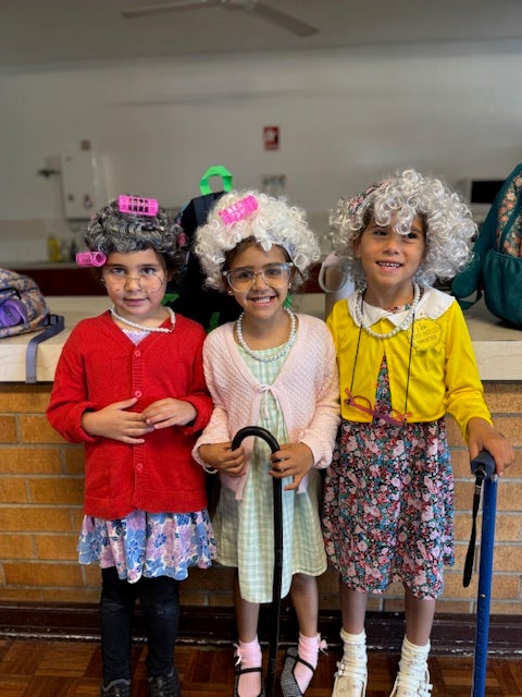 three students dressed up as grandparents