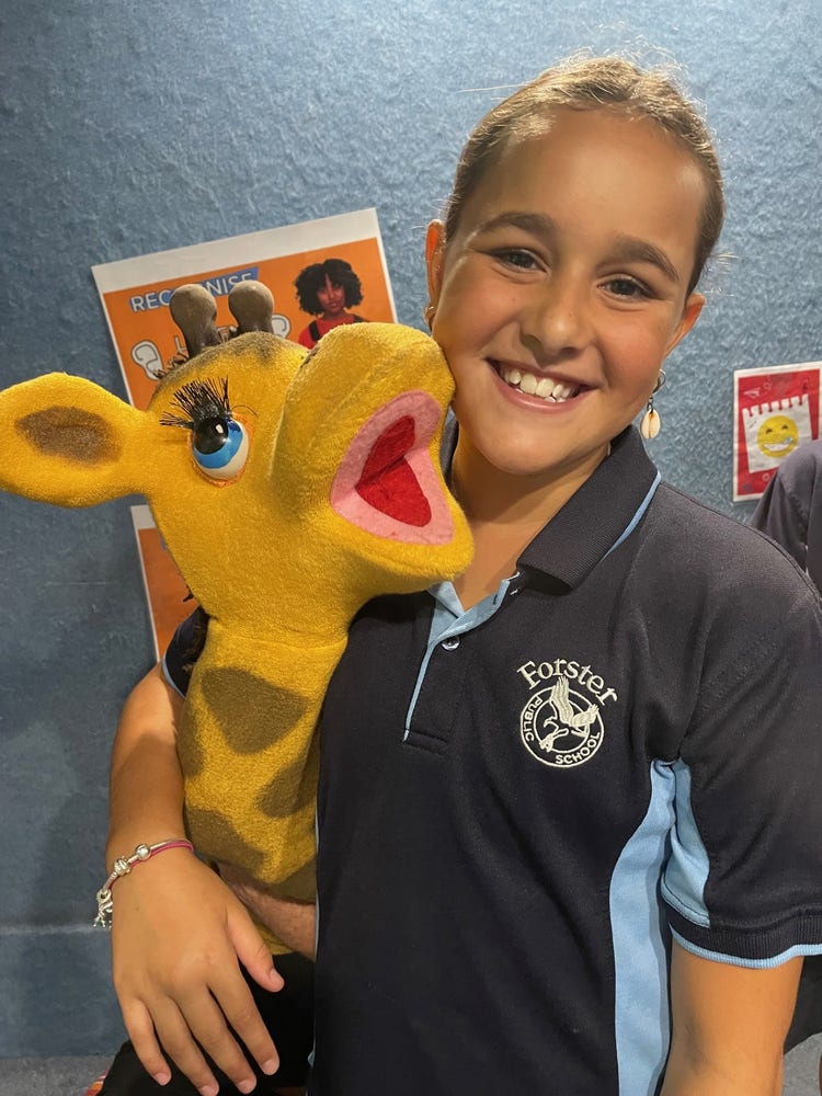 student hugging a giraffe