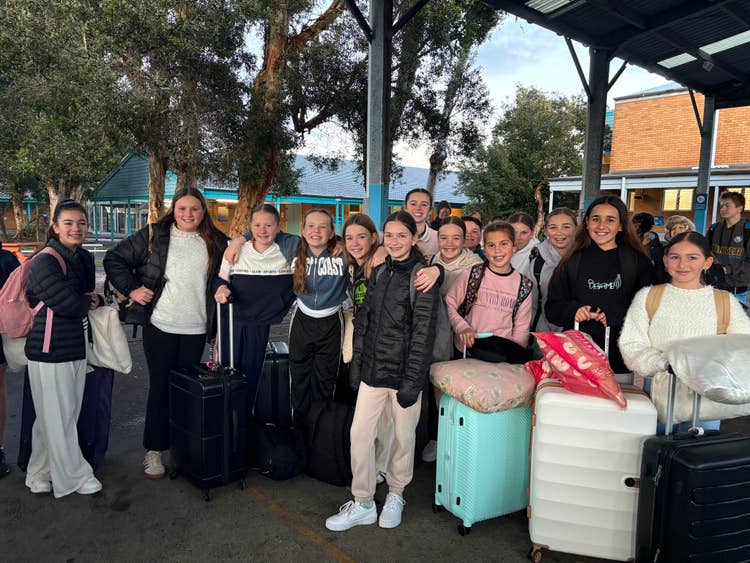 group of students with suitcases