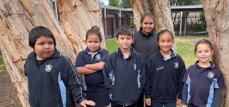 six students in the playground in a group