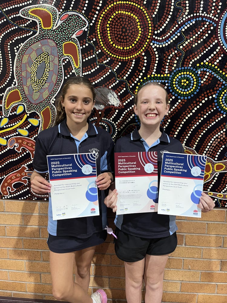 two girls holding certificates